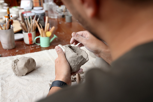 Ceramic artist sculpting clay and making bowls