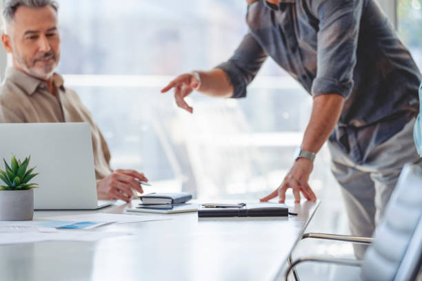 istock Businessmen meeting at the boardroom table. 1325121919