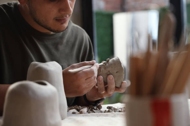 istock Ceramic artist sculpting clay and making bowls 1325121940