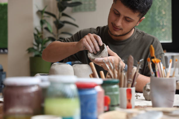 istock Ceramic artist sculpting clay and making bowls 1325122037