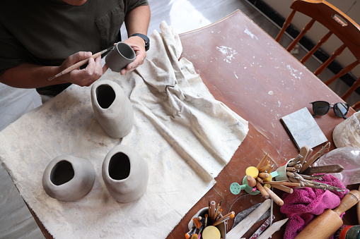 Woman Artisan Making Ceramics - Pouring Liquid Clay into the Mold