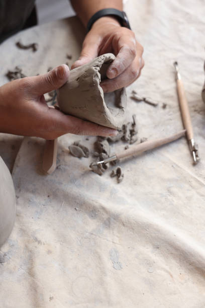 istock Ceramic artist sculpting clay and making bowls 1325122177