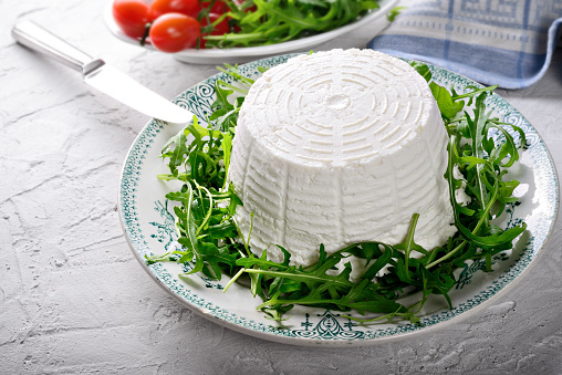 Fresh cottage cheese with cow or sheep milk, close-up.