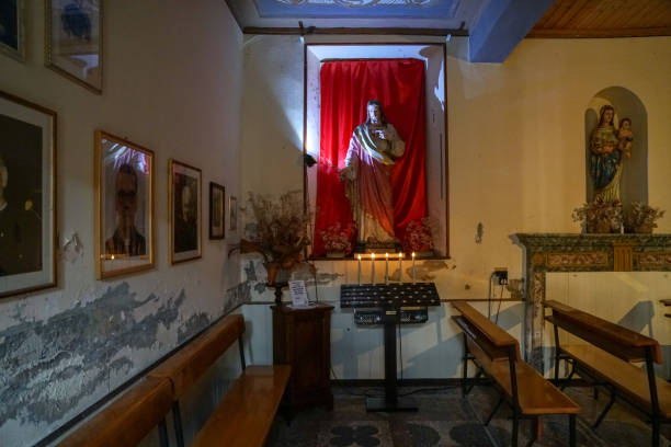 Pella - 07/12/2020: interior of small church with Christ statue and votive candles