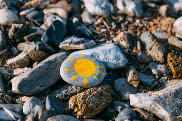 istock Sun Painted on Pebbles on the Beach 1325124477