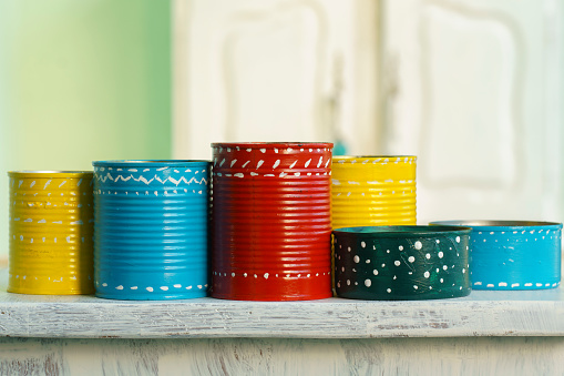 set of cans decorated and painted in multiple colors