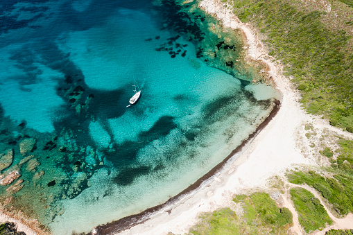 View from above, stunning aerial view of a wild beach bathed by a beautiful turquoise sea. Sardinia, Sardinia, Italy.