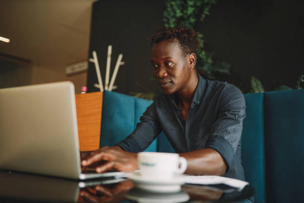 istock Young man doing work on the laptop in the cafe 1325137991