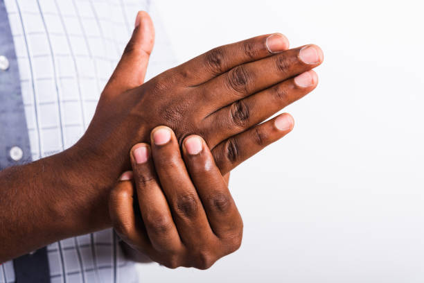 istock black man holds his palm hand injury, feeling pain 1325142017