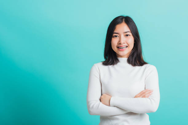istock woman smiling with crossed arms 1325142026