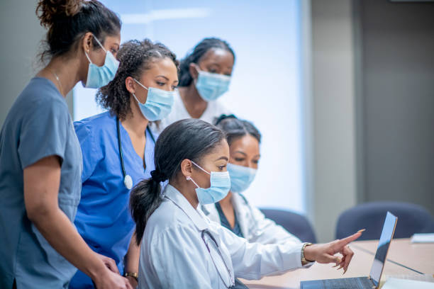 Group of female medical researchers A diverse group of doctors and nurses discuss medical data. medical student stock pictures, royalty-free photos & images