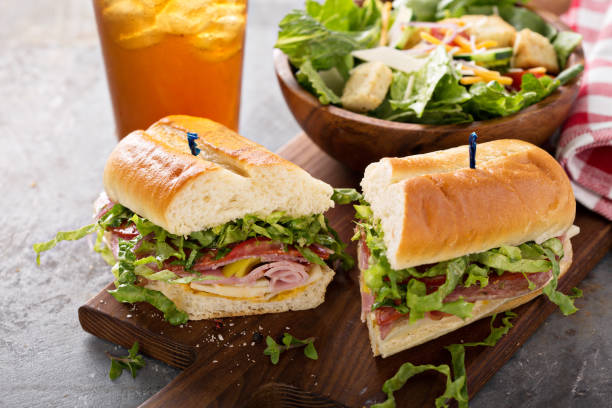 Italian sandwich for lunch Italian meat sandwich with salad and chips for lunch delicatessen stock pictures, royalty-free photos & images