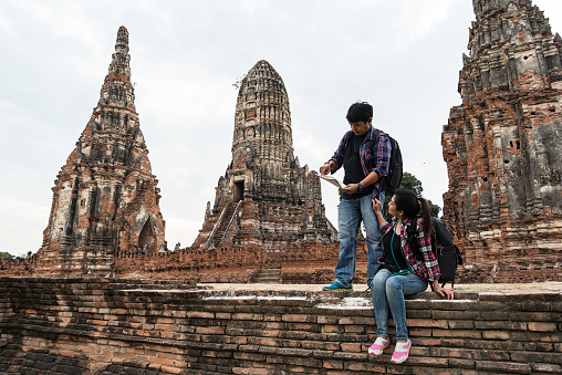 Young tourist with backpack walking in temple Ayuttaya ,Thailand