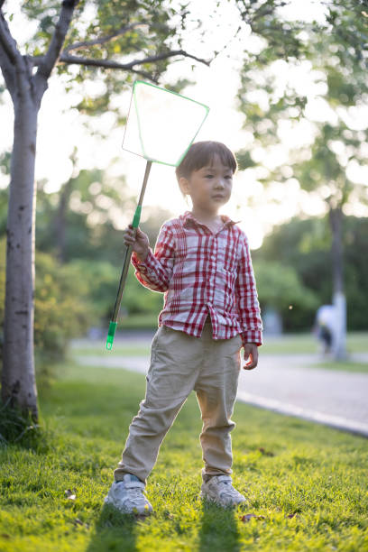 istock Asian boys playing in the park 1325148901