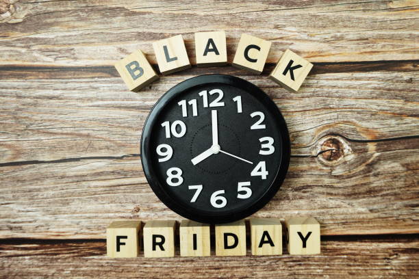 istock Black Friday with Clock on wooden background 1325149692