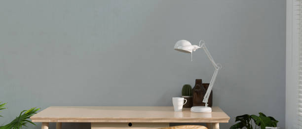 istock Wooden table with lamp, cup, decorations and copy space with loft wall background, 3D render 1325149784