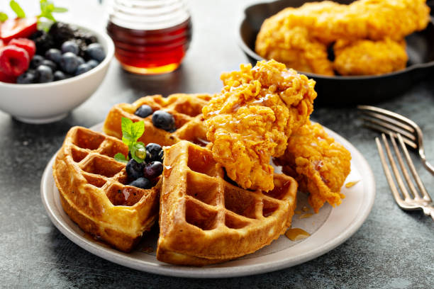 Waffles with fried chicken Waffles with fried chicken and maple syrup, southern comfort food waffle stock pictures, royalty-free photos & images