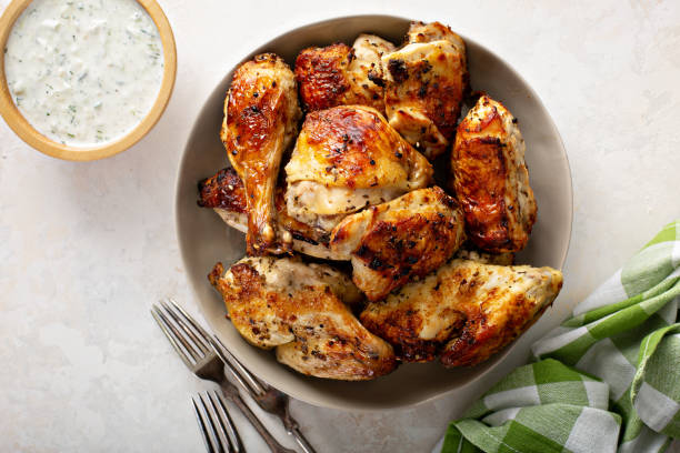 Roasted chicken with tzatziki sauce Roasted chicken with tzatziki sauce, greek inspired lunch chicken leg stock pictures, royalty-free photos & images