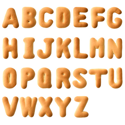 Overhead shot of uppercase alphabetical order in biscuit on white background.