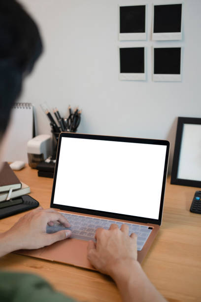 istock Young man working with laptop at home office. 1325159040