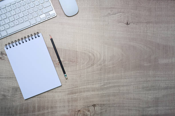 istock Top view empty notepad, pen and keyboard on wooden background. 1325159104
