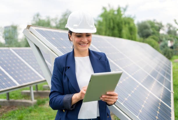 istock A Female Manager Engineer İn Safety Helmet Checking With Tablet An Operation Of Solar Panel System At Solar Station 1325161594
