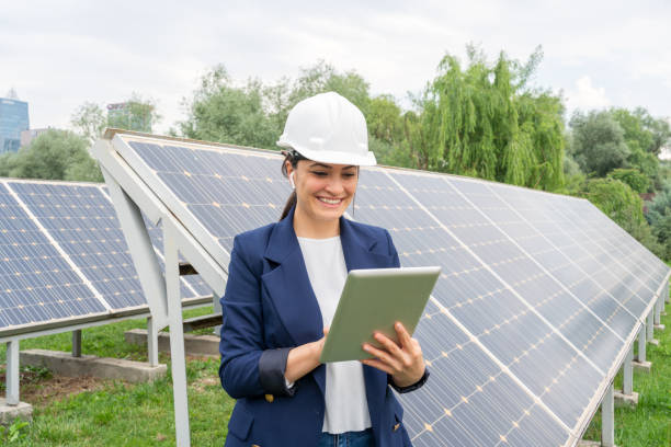 istock A Female Manager Engineer İn Safety Helmet Checking With Tablet An Operation Of Solar Panel System At Solar Station 1325161749