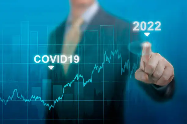 Photo of economic recovery in 2022. timeline chart diagram of global economic recovery after the crisis caused by the covid19 pandemic. Businessman pointing graph corporate future growth plan on dark blue