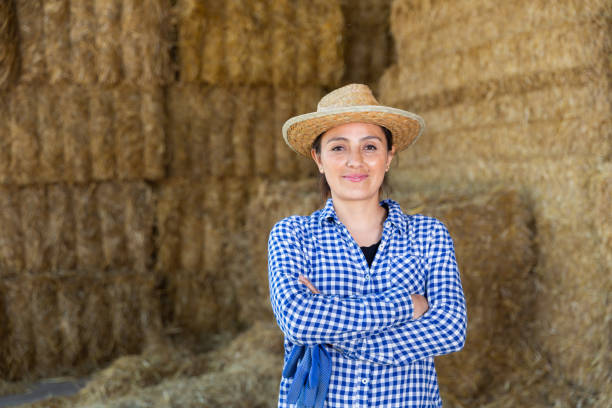istock Successful young female farmer posing near straw stack 1325162836