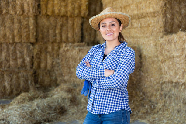istock Successful young female farmer posing near straw stack 1325162839