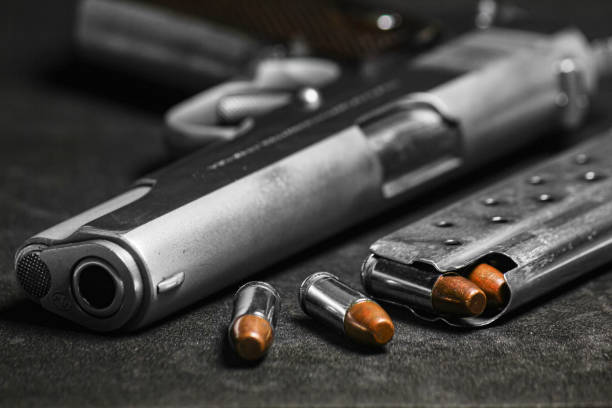 istock Automatic white gun stainless steel pistol weapon model m1911 with real bullet ammo and magazine with black background 1325163534