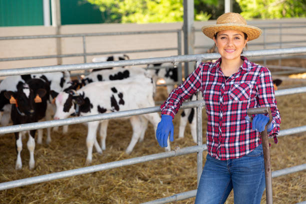 istock Successful young female cow breeder standing in cowshed 1325163746
