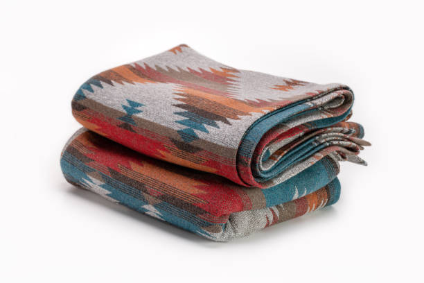istock Several luxurious multi-colored throw wool blanket. Elegant textile background in Pendelton style. 1325164418