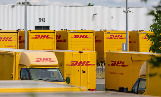 Neuwied, Germany - June 20, 2021: DHL delivery vans and containers in front of a DHL depot