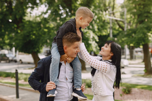 istock Cute family playing in a summer park 1325164710