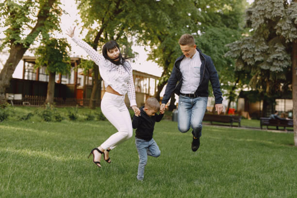 istock Cute family playing in a summer park 1325164794
