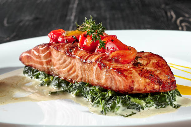 istock Grilled salmon steak with stewed spinach in cream 1325165390