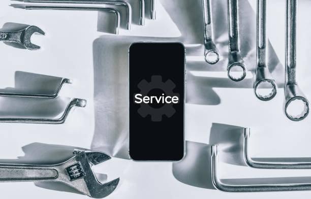 istock Repair phone. Technician workplace with phone and special repairing tools. Disassembling, diagnostic and repairman smartphone. 1325165743