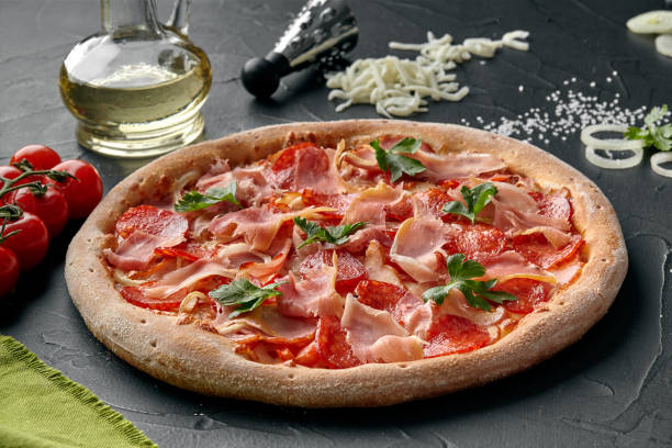 istock Italian meat pizza with salami, bacon and prosciutto 1325165788