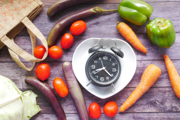 istock fresh vegetables and alarm clock on heart shape plate on table 1325166390