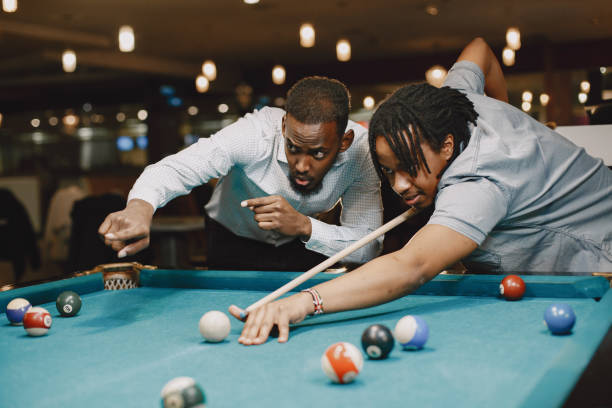 istock Men playing billiards in a club 1325167483