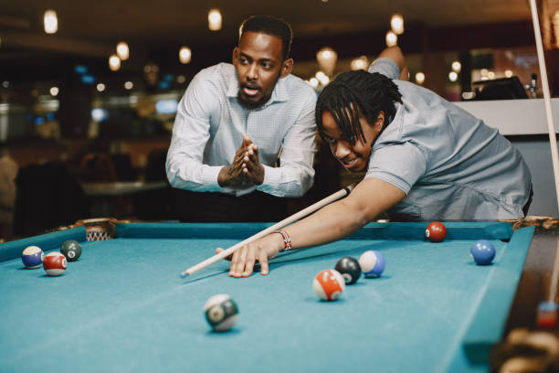 istock Men playing billiards in a club 1325167489