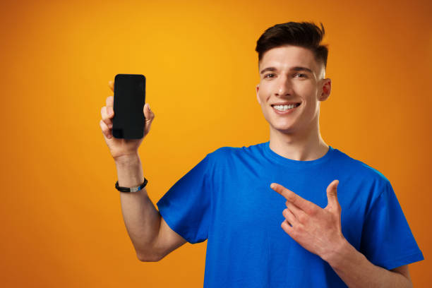 istock Young handsome man showing black smartphone screen 1325171385