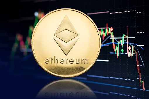 Galicia, Spain; April 19, 2021: Ethereum coin and stock chart background with price falling. Cryptocurrency