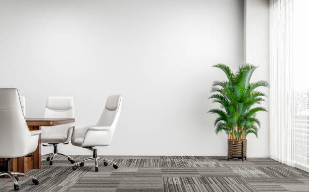 Empty office interior with conference table and potted plant stock photo
