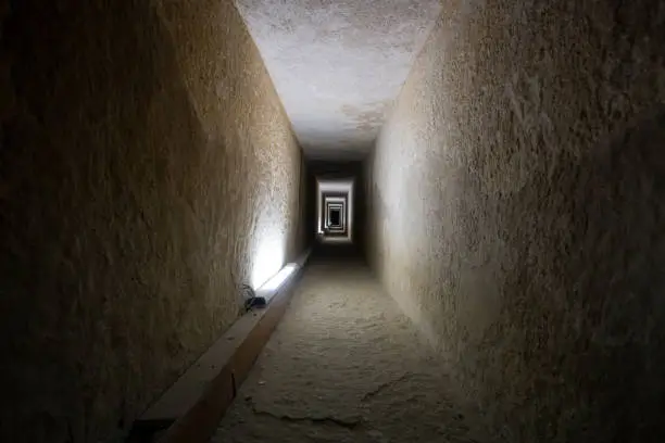 Photo of Tunnel entrance to the ancient Egyptian pyramid. A long passage in the pyramid of Giza. A prehistoric landmark. Giza, Cairo, Egypt. inside second pyramid.