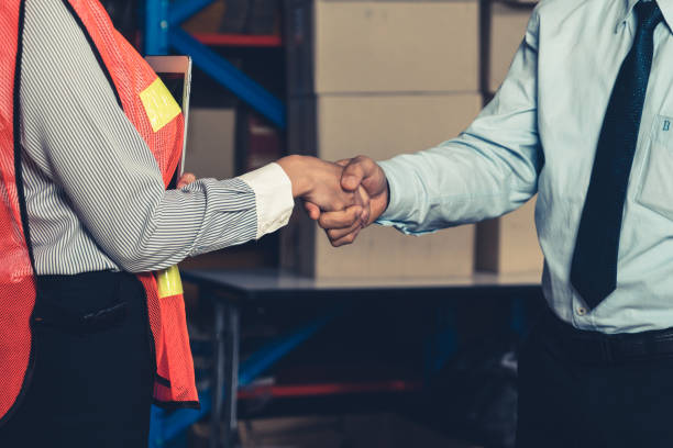 istock Warehouse worker handshake with manager in storehouse 1325179766