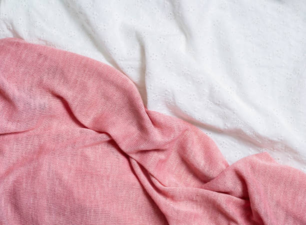 istock Background white cotton fabric and pink knitted fabric. 1325180888