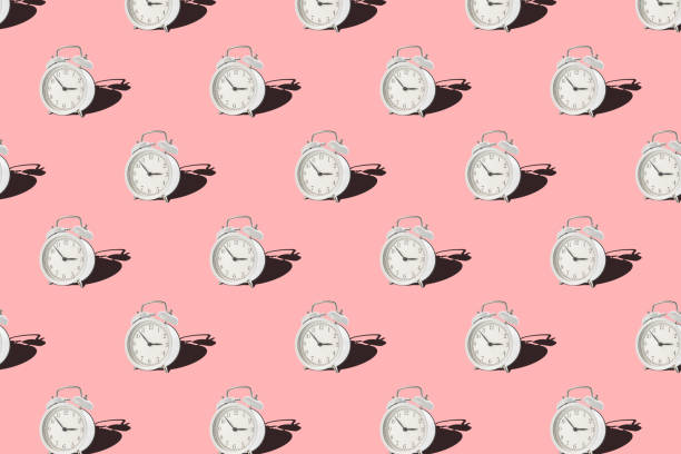 istock Seamless pattern with vintage alarm clock on pink background 1325181121