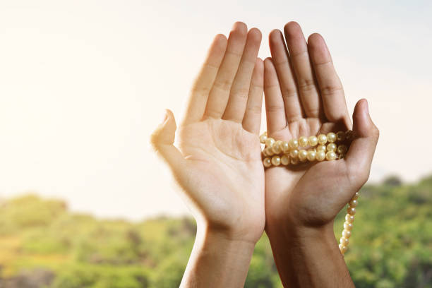 istock Muslim man praying with prayer beads on his hands 1325182141